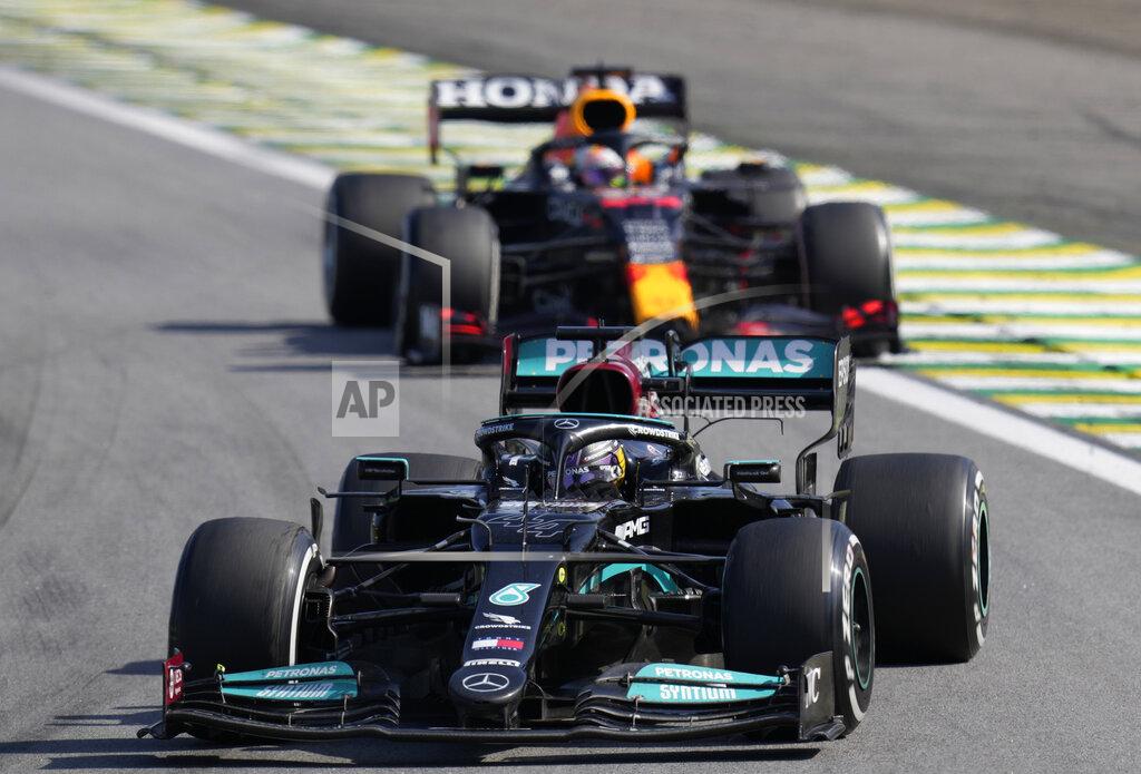 Andre Penner Mercedes' Lewis Hamilton, front, steers his car followed by Red Bull's Max Verstappen , during the Brazilian Formula One Grand Prix at the Interlagos race track in Sao Paulo, Brazil, Sunday, Nov. 14, 2021. (AP Photo/Andre Penner)