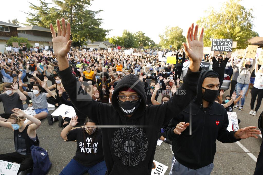 Rich Pedroncelli Darin Steele, center, holds up his hands with other protesters, Friday, June, 5, 2020, during a demonstration in Sacramento, Calif., against police violence and the death of George Floyd. Floyd, a black man, died after being restrained by Minneapolis police officers on May 25. (AP Photo/Rich Pedroncelli)
