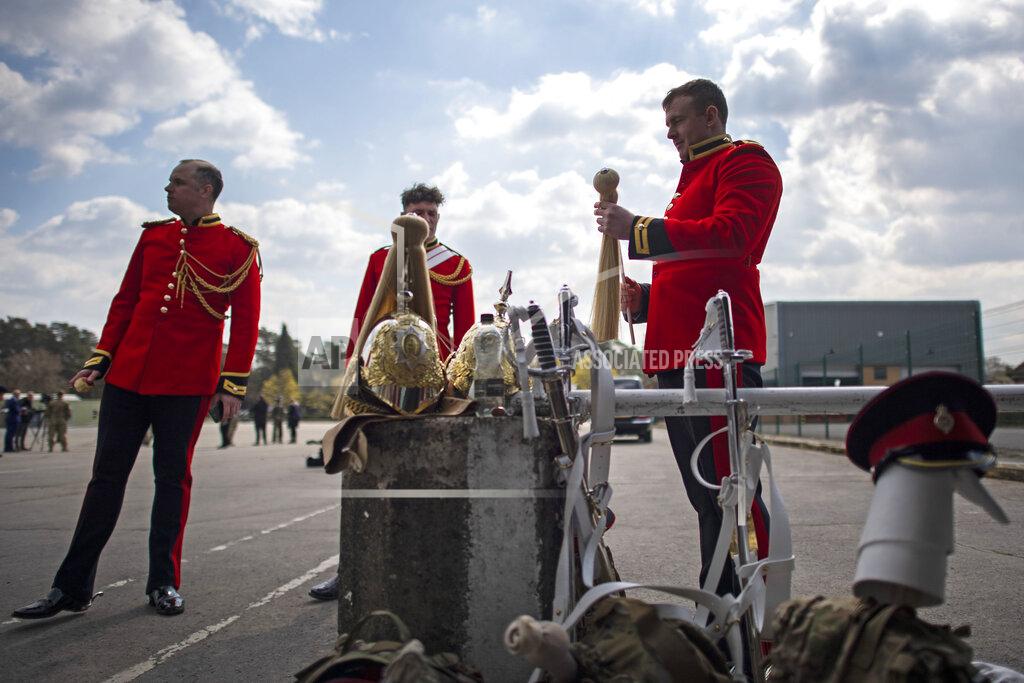 Victoria Jones A soldier from the Household Calvary Life Guards prepares his uniform before rehearsing for Britain's Prince Philip's funeral on the Drill Square at the Army Training Centre Pirbright in Woking, Surrey, England Wednesday April 14, 2021. Prince Philip's funeral will be held at Windsor Castle on Saturday following his death at the age of 99 on April 10. (Victoria Jones/PA via AP)