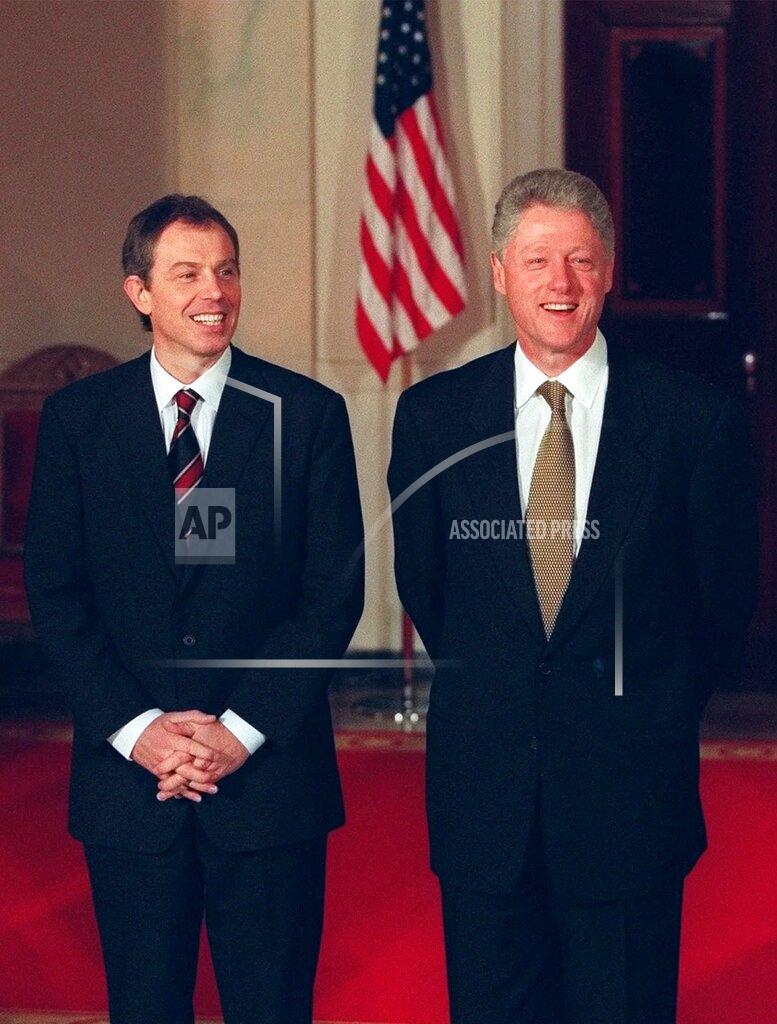 J. Scott Applewhite FILE - In this Feb. 5, 1998, file photo President Bill Clinton, right, and British Prime Minister Tony Blair stand during a welcoming ceremony for Blair at the White House in Washington. On Feb. 6, 1988, during a Clinton news conference he was asked at what point he might decide the crisis was too much to put his family through anymore and resign. “Never," he said, stone-faced. (AP Photo/J. Scott Applewhite, File)