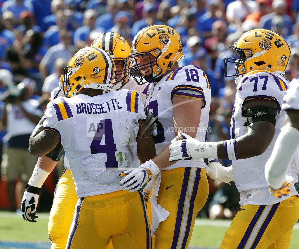 John Raoux LSU players, including tight end Foster Moreau (18) and offensive tackle Saahdiq Charles (77) celebrate with running back Nick Brossette (4) after he scored a touchdown against Florida on a 4-yard run durinng the first half of an NCAA college football game, Saturday, Oct. 6, 2018, in Gainesville, Fla. (AP Photo/John Raoux)