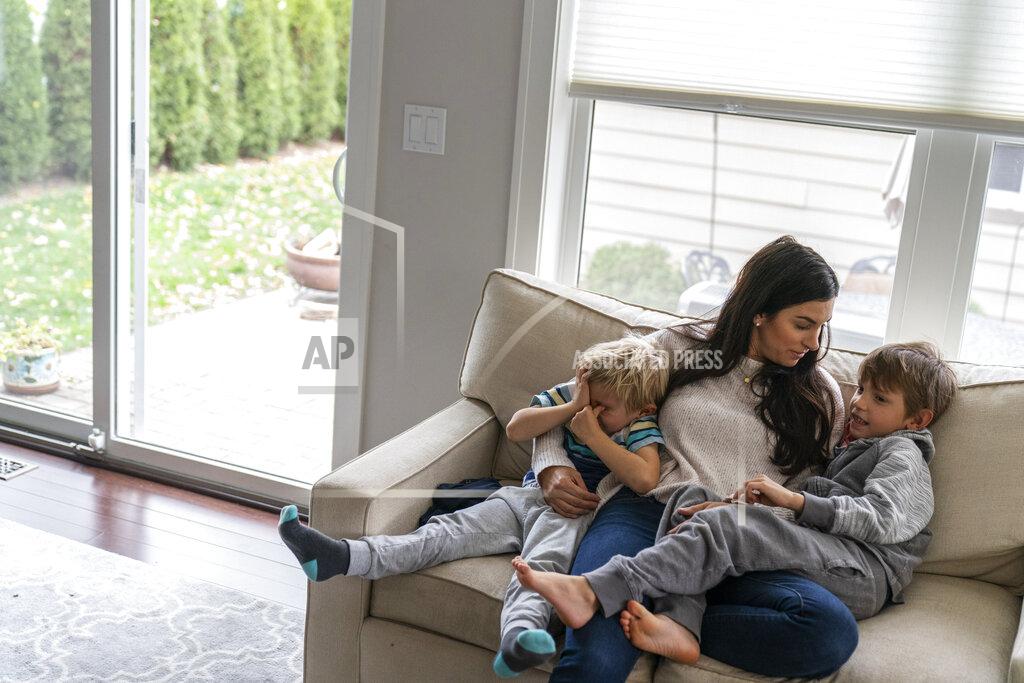 David Goldman Meghan Iliesiu sits with her sons, Gabriel, 6, right, and Alexander, 4, at their home in Huntington Woods, Mich., Friday, Oct. 30, 2020. Iliesiu, a 32-year-old stay-at-home mother in Oakland County, voted third-party in 2016. She never thought Trump would win. Now she believes he's made the country more hateful and divided. She decided long ago to vote for any Democrat who ran against him. Now the wait is excruciating, Iliesiu said. (AP Photo/David Goldman)