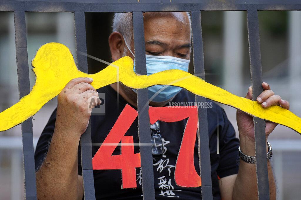 Vincent Yu A protester stands behind a mock prison during a protest against an election committee that will vote for the city's leader in Hong Kong Sunday, Sept.19, 2021. Hong Kong's polls for an election committee that will vote for the city's leader kicked off Sunday amid heavy police presence, with chief executive Carrie Lam saying that it is "very meaningful" as it is the first election to take place following electoral reforms. (AP Photo/Vincent Yu)