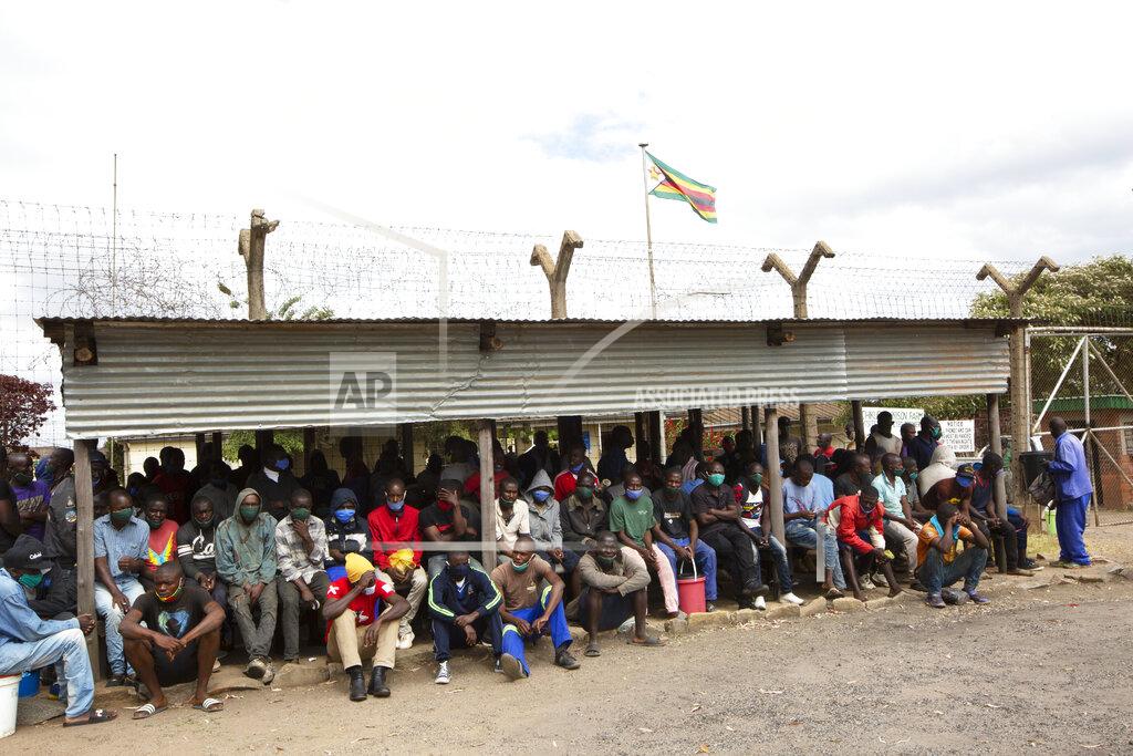 Tsvangirayi Mukwazhi Prisoners wait for transport following their release from Chikurubi prison on the outskirts of Harare, Saturday, April 17, 2021. Zimbabwe began the release of about 3,000 prisoners under a presidential amnesty aimed at easing congestion and minimizing the threat of COVID-19 across the country's overcrowded jails. (AP Photo/Tsvangirayi Mukwazhi)