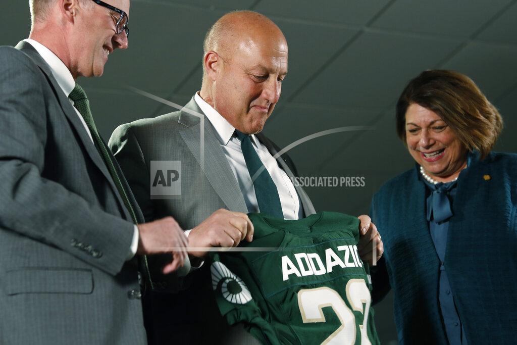 David Zalubowski Steve Addazio, center, looks down at a jersey presented to him by athletic director Joe Parker, left, and President Joyce McConnell during an announcement that Addazio has been hired as the new head football coach at Colorado State University at a news conference at the school Thursday, Dec. 12, 2019, in Fort Collins, Colo. (AP Photo/David Zalubowski)
