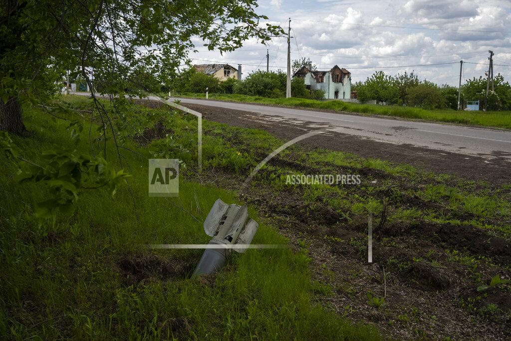 Bernat Armangue An unexploded projectile lies on a side street in the town of Vilkhivka, on the outskirts of Kharkiv, in eastern Ukraine, Friday, May 20, 2022.. (AP Photo/Bernat Armangue)