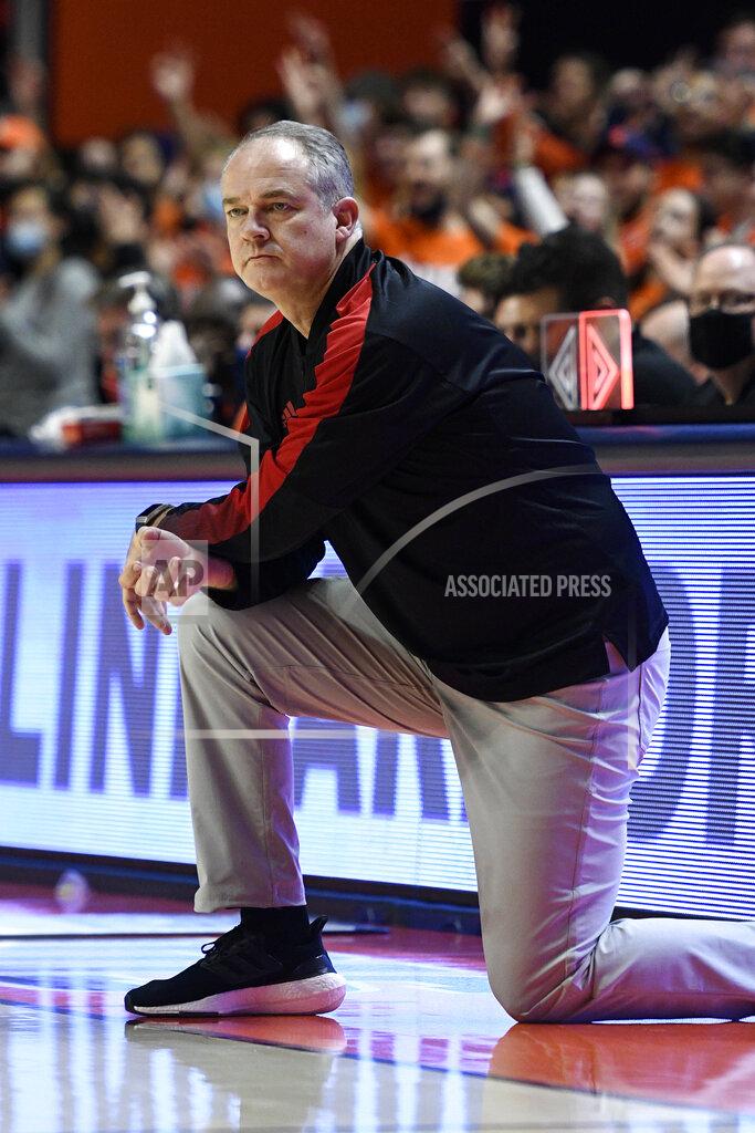 Michael Allio Rutgers coach Steve Pikiell kneels during the first half of the team's NCAA college basketball game against Illinois on Friday, Dec. 3, 2021, in Champaign, Ill. (AP Photo/Michael Allio)