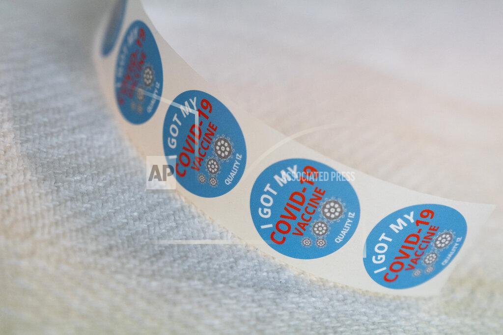 Jacquelyn Martin In this Wednesday, Feb. 10, 2021, photo stickers are at the ready as healthcare workers and people over the age of 65 receive COVID-19 vaccinations at United Medical Center in southeast Washington. (AP Photo/Jacquelyn Martin)