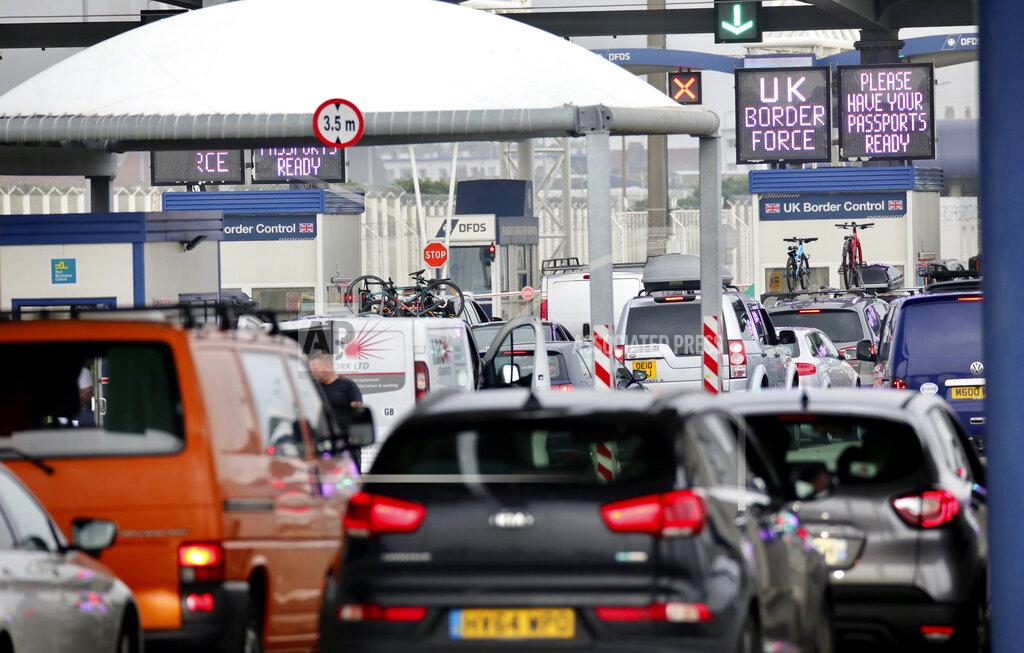 Olivier Matthys People queue in line to check-in for the cross channel ferry in Calais, France, Friday Aug.14, 2020. British holiday makers in France were mulling whether to return home early Friday to avoid having to self-isolate for 14 days following the U.K. government's decision to reimpose quarantine restrictions on France amid a recent pick-up in coronavirus infections. (AP Photo/Olivier Matthys)