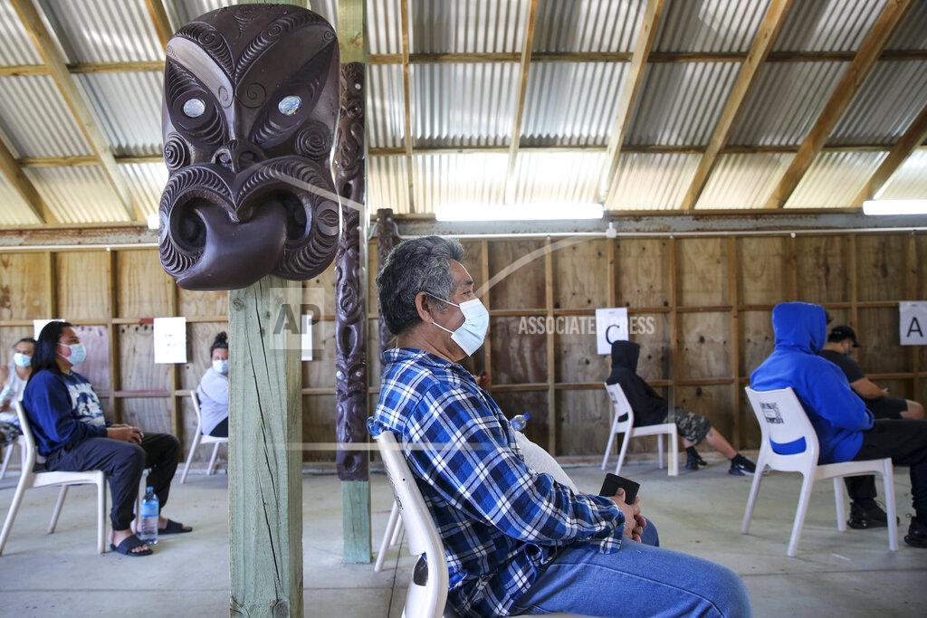 Sylvie Whinray New Zealanders wait to be vaccinated at Manurewe Marae vaccination center in Auckland, New Zealand, Saturday, Oct 21, 2021. New Zealand's government said Tuesday it will expand a vaccine mandate to include thousands of workers who have close contact with their customers, including those at restaurants, bars, gyms and hair salons. (Sylvie Whinray/New Zealand Herald via AP)