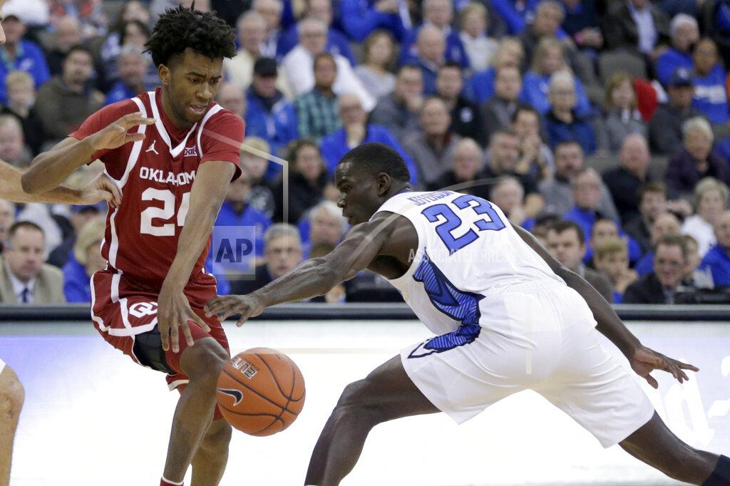 Nati Harnik Creighton's Damien Jefferson (23) attempts to steal the ball from Oklahoma's Jamal Bieniemy (24) during the first half of an NCAA college basketball game in Omaha, Neb., Tuesday, Dec. 17, 2019. (AP Photo/Nati Harnik)