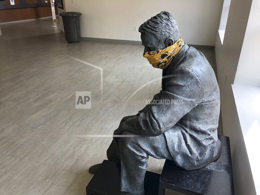 Jeff Amy A statue is masked inside a building on the first day of classes Monday, August 17, 2020, at Georgia Tech in Atlanta. More of Georgia's public universities are opening for the fall term, trying to balance concern about COVID-19 infections against a mandate for on-campus classes citing financial needs and student desires (AP Photo/Jeff Amy)