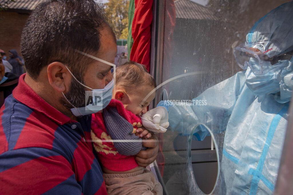 Dar Yasin A Kashmiri health worker takes a nasal swab sample of a child to test for COVID-19 in Srinagar, Indian-controlled Kashmir, Tuesday, Oct. 6, 2020. India is the second worst-nation in terms of confirmed coronavirus caseload. (AP Photo/ Dar Yasin)