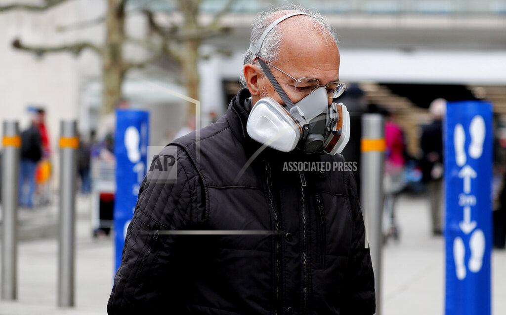 Frank Augstein A shopper wears a face mask as he queues at a supermarket due to the coronavirus related lockdown in London, Friday, April 17, 2020. The highly contagious COVID-19 coronavirus has impacted on nations around the globe, many imposing self isolation and exercising social distancing when people move from their homes.(AP Photo/Frank Augstein)