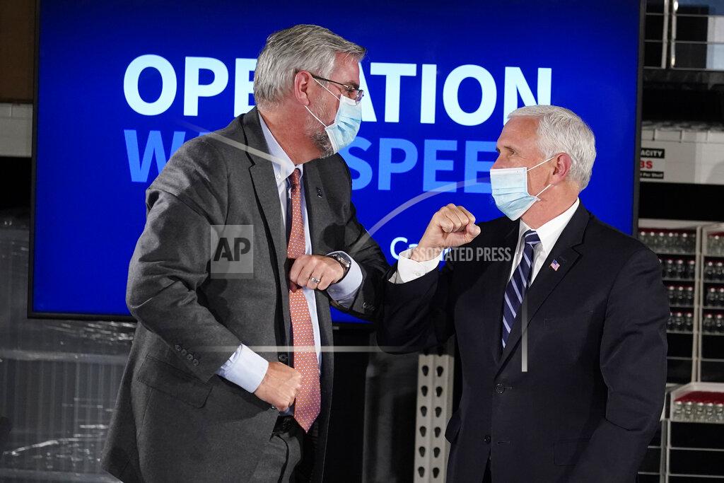 Darron Cummings Vice President Mike Pence elbow bumps Indiana Gov. Eric Holcomb following a round table discussion at Catalent Biologics, Tuesday, Dec. 15, 2020, in Bloomington, Ind. (AP Photo/Darron Cummings)