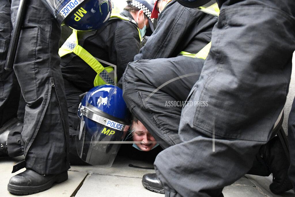Alberto Pezzali A woman is detained by police during a 'Kill the Bill' protest in London, Saturday, April 3, 2021. The demonstration is against the contentious Police, Crime, Sentencing and Courts Bill, which is currently going through Parliament and would give police stronger powers to restrict protests. (AP Photo/Alberto Pezzali)
