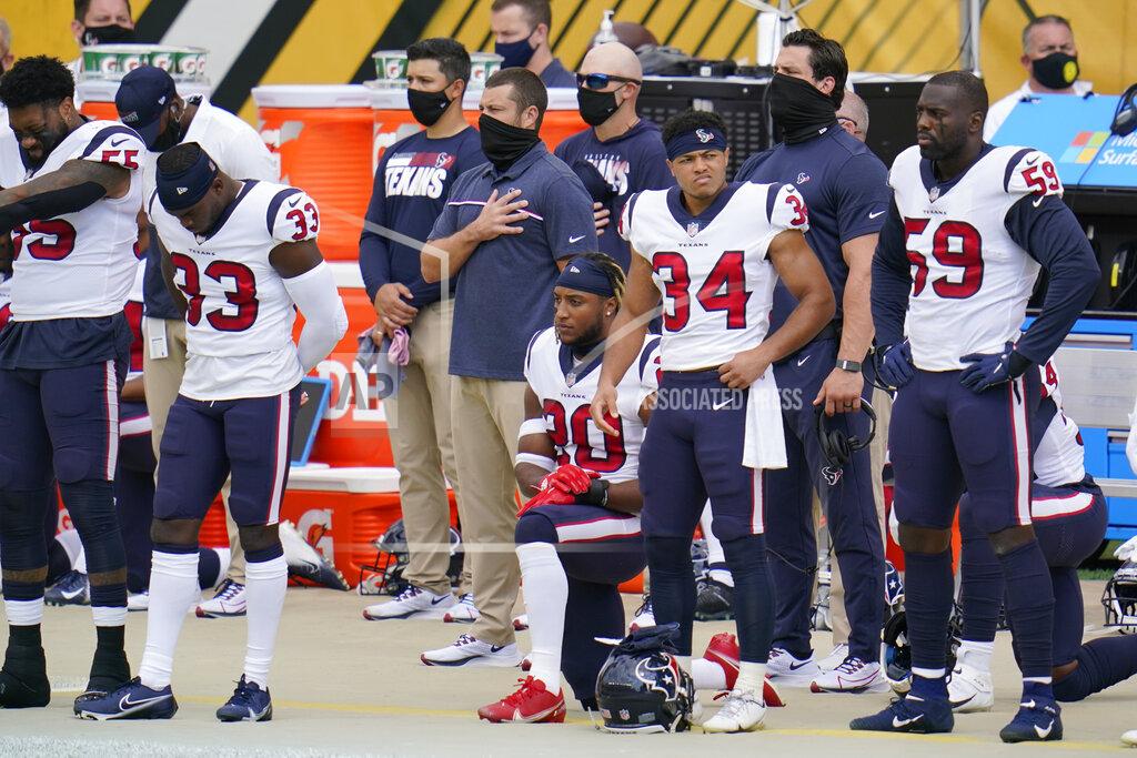 Gene J. Puskar Some of the Houston Texans kneel as others stand for the playing of the National Anthem before an NFL football game against the Pittsburgh Steelers, Sunday, Sept. 27, 2020, in Pittsburgh. (AP Photo/Gene J. Puskar)