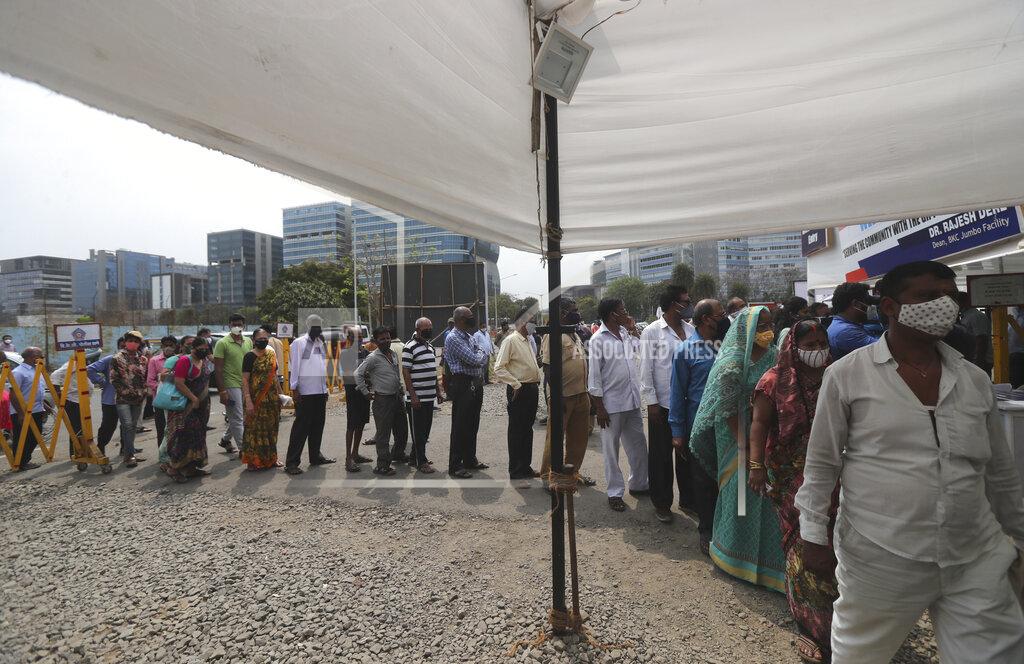 Rafiq Maqbool People queue up for COVID-19 vaccine in Mumbai, India, Thursday, April 8, 2021. Nations around the world set new records Thursday for COVID-19 deaths and new coronavirus infections, and the disease surged even in some countries that have kept the virus in check. Indian Prime Minister Narendra Modi urged people to get vaccinated, writing in a tweet: “Vaccination is among the few ways we have to defeat the virus. If you are eligible for the vaccine, get your shot soon.” (AP Photo/Rafiq Maqbool)