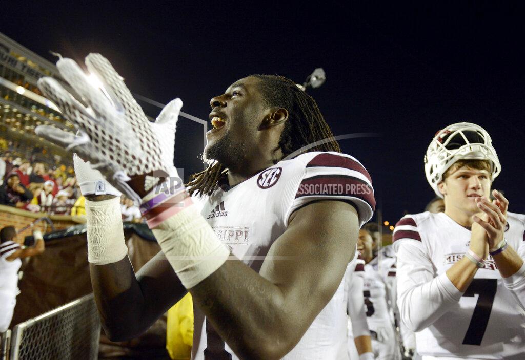 L.g. Patterson FILE - In this Nov. 5, 2015, file photo, Mississippi State wide receiver De'Runnya Wilson, left, and quarterback Nick Fitzgerald, right, celebrate with the rest of their team after defeating Missouri 31-13 in an NCAA college football game in Columbia, Mo. Authorities say the death of Wilson, a former Mississippi State football player whose body was found in an Alabama home Tuesday, Jan. 21, 2020, is being investigated as a homicide. (AP Photo/L.G Patterson, File)