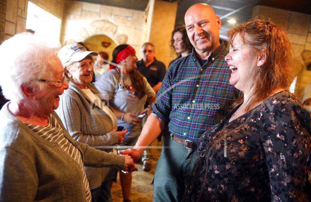 John Haeger Catherine Toborowski, left, of Shenandoah Heights, and Sandi Gera of West Mahanoy Township, speak with state Sen. Doug Mastriano, R-District 33, a Republican gubernatorial candidate, and his wife Rebecca during a campaign stop at Alfredo's Brick Oven Pizza in Hazleton, Pa., on Friday, May 13, 2022.(John Haeger/Standard-Speaker via AP)
