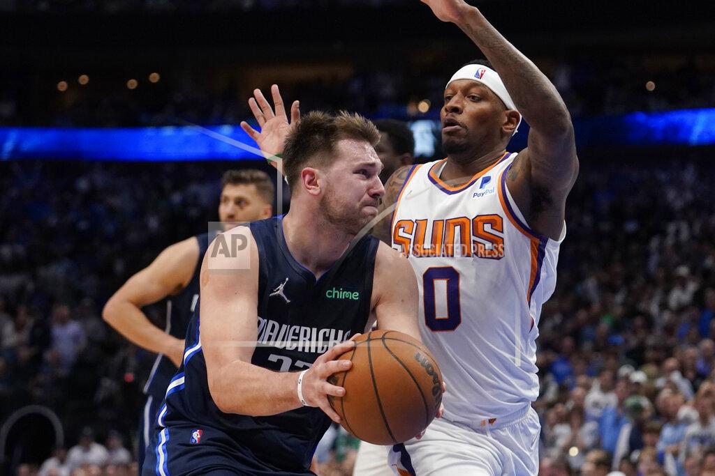 Tony Gutierrez Dallas Mavericks guard Luka Doncic, left, drives to the basket against Phoenix Suns forward Torrey Craig (0) during the second half of Game 6 of an NBA basketball second-round playoff series, Thursday, May 12, 2022, in Dallas. (AP Photo/Tony Gutierrez)