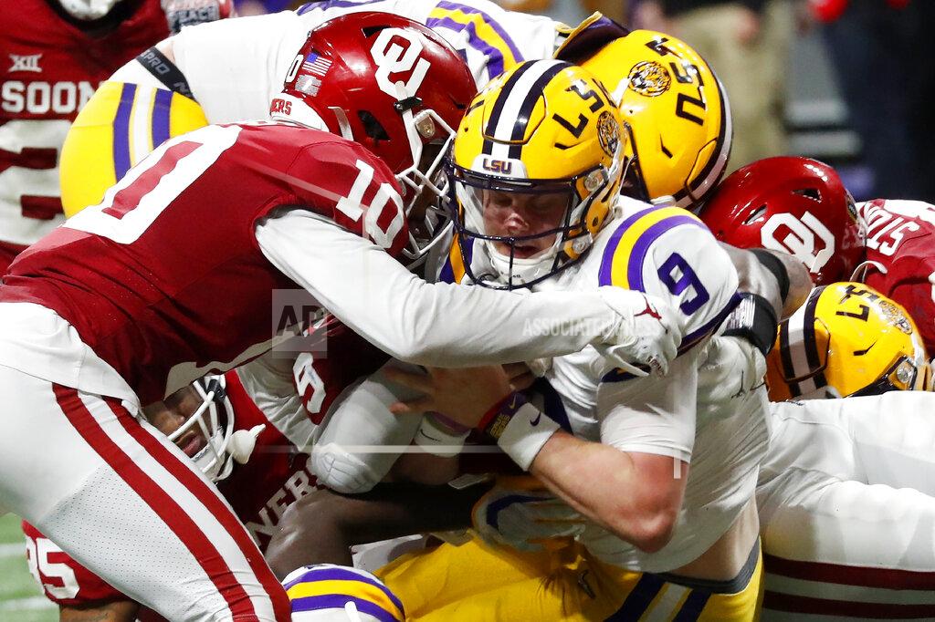 LSU quarterback Joe Burrow (9) runs into the end zone for a touchdown against Oklahoma during the second half of the Peach Bowl NCAA semifinal college football playoff game, Saturday, Dec. 28, 2019, in Atlanta. (AP Photo/John Bazemore)