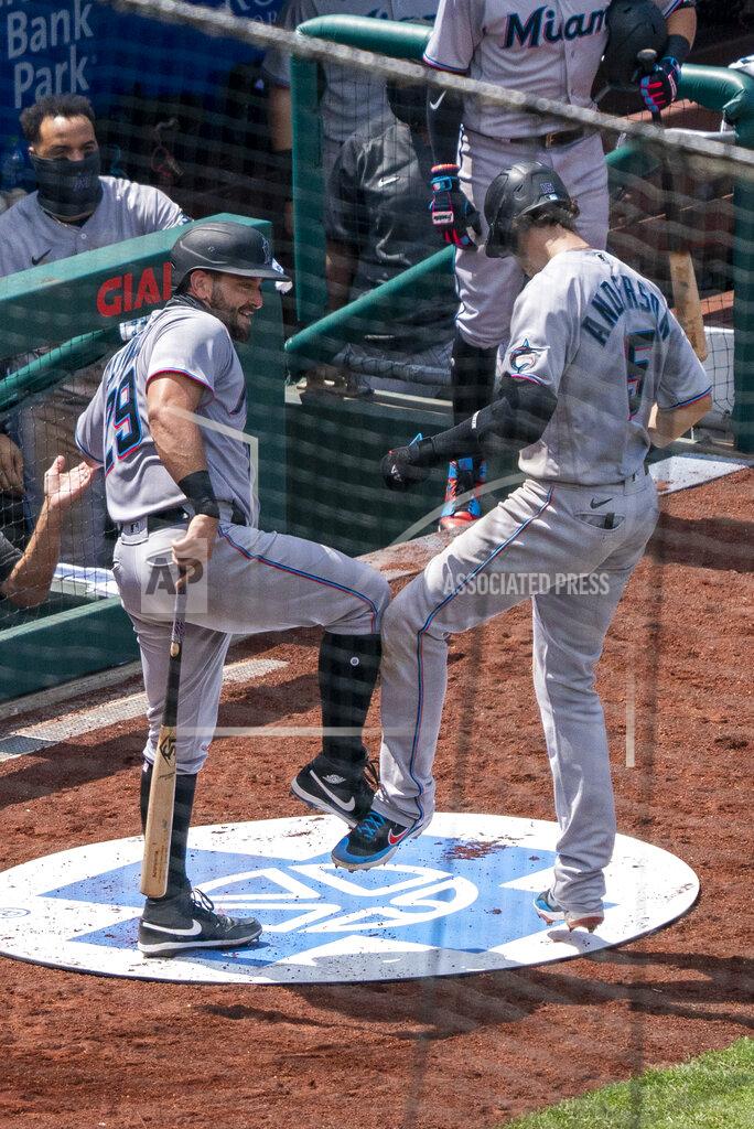 Miami Marlins' Brian Anderson, right, celebrates his two-run home run with Francisco Cervelli, left, during the fifth inning of a baseball game against the Philadelphia Phillies, Sunday, July 26, 2020, in Philadelphia. (AP Photo/Chris Szagola)
