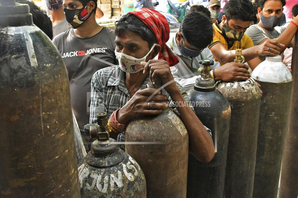 Ishant Chauhan Indians wait to refill oxygen cylinders for COVID-19 patients at a gas supplier facility in New Delhi, India, Saturday, May 8, 2021. Infections have swelled in India since February in a disastrous turn blamed on more contagious variants as well as government decisions to allow massive crowds to gather for religious festivals and political rallies. (AP Photo/Ishant Chauhan)