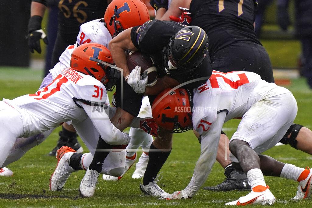 Nam Y. Huh Northwestern running back Evan Hull, center, is tackled by Illinois defenders during the second half of an NCAA college football game in Evanston, Ill., Saturday, Dec. 12, 2020. Northwestern won 28-10. (AP Photo/Nam Y. Huh)