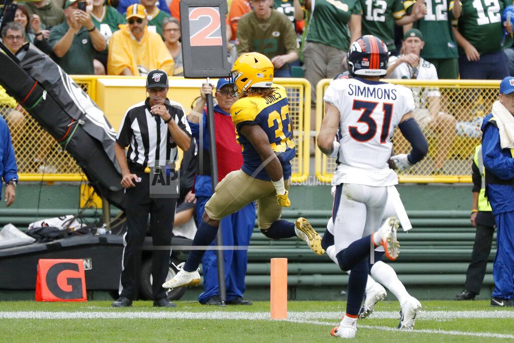 Matt Ludtke Green Bay Packers running back Aaron Jones (33) scores past Denver Broncos free safety Justin Simmons (31) during the second half of an NFL football game Sunday, Sept. 22, 2019, in Green Bay, Wis. (AP Photo/Matt Ludtke)