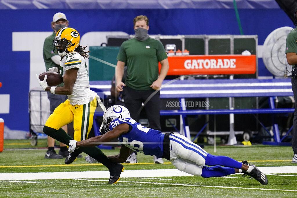 Michael Conroy Green Bay Packers' Davante Adams (17) is tackled by Indianapolis Colts' Rock Ya-Sin (26) during the first half of an NFL football game, Sunday, Nov. 22, 2020, in Indianapolis. (AP Photo/Michael Conroy)