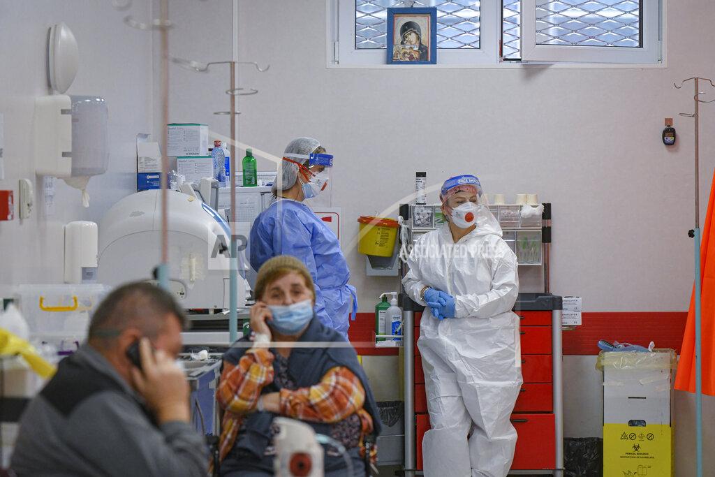 Andreea Alexandru Patients speak on mobile phones in the emergency room, turned into a CODIV-19 unit due the high number of cases, at the Bagdasar-Arseni hospital in Bucharest, Romania, Tuesday, Oct. 12, 2021. Romania reported on Tuesday nearly 17,000 new COVID-19 infections and 442 deaths, the highest number of coronavirus infections and deaths in a day since the pandemic started, as the nation's health care system struggles to cope with an acute surge of new cases.(AP Photo/Andreea Alexandru)