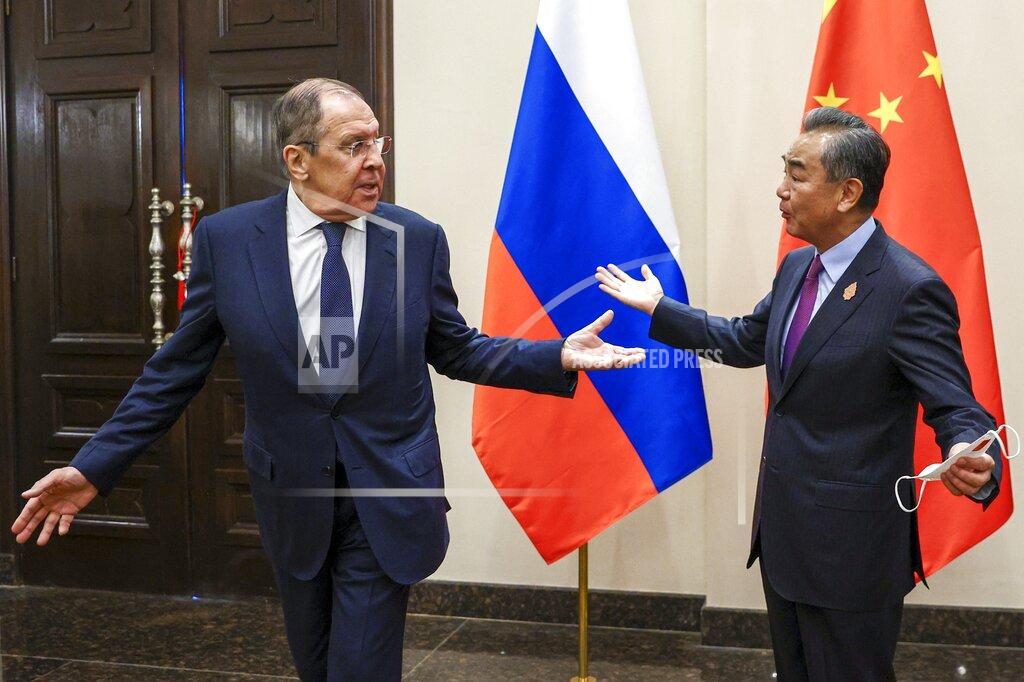 Uncredited In this handout photo released by Russian Foreign Ministry Press Service, Russian Foreign Minister Sergey Lavrov, left, and Chinese Foreign Minister Wang Yi gesture during their bilateral meeting ahead of the G20 Foreign Ministers' Meeting in Nusa Dua, Bali, Indonesia, Thursday, July 7, 2022. (Russian Foreign Ministry Press Service via AP)