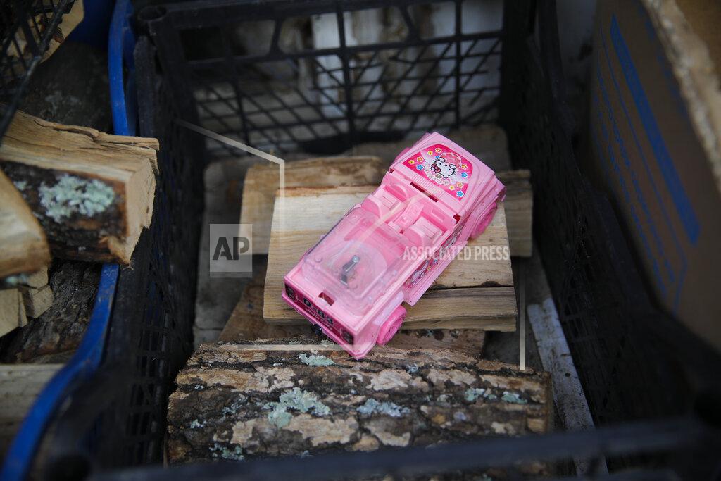 Vadim Ghirda A toy car is placed on fire wood stored in a village on the outskirts of Burgas, Bulgaria, Monday, Sept. 28, 2020. Human rights activists and experts say local officials in several countries with significant Roma populations have used the pandemic to unlawfully target the minority group, which is Europe's largest and has faced centuries of severe discrimination. In Bulgaria, Roma communities were sprayed with disinfectant from crop dusters this spring as coronavirus cases surged in the country.(AP Photo/Vadim Ghirda)