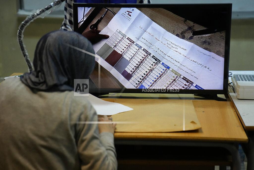 Hussein Malla A candidate representative watches a screen displaying ballots after the close of a polling station at the end of the parliamentary election day, in Beirut, Lebanon, Sunday, May 15, 2022. Lebanese voted for a new parliament Sunday against the backdrop of an economic meltdown that is transforming the country and low expectations that the election would significantly alter the political landscape. (AP Photo/Hussein Malla)