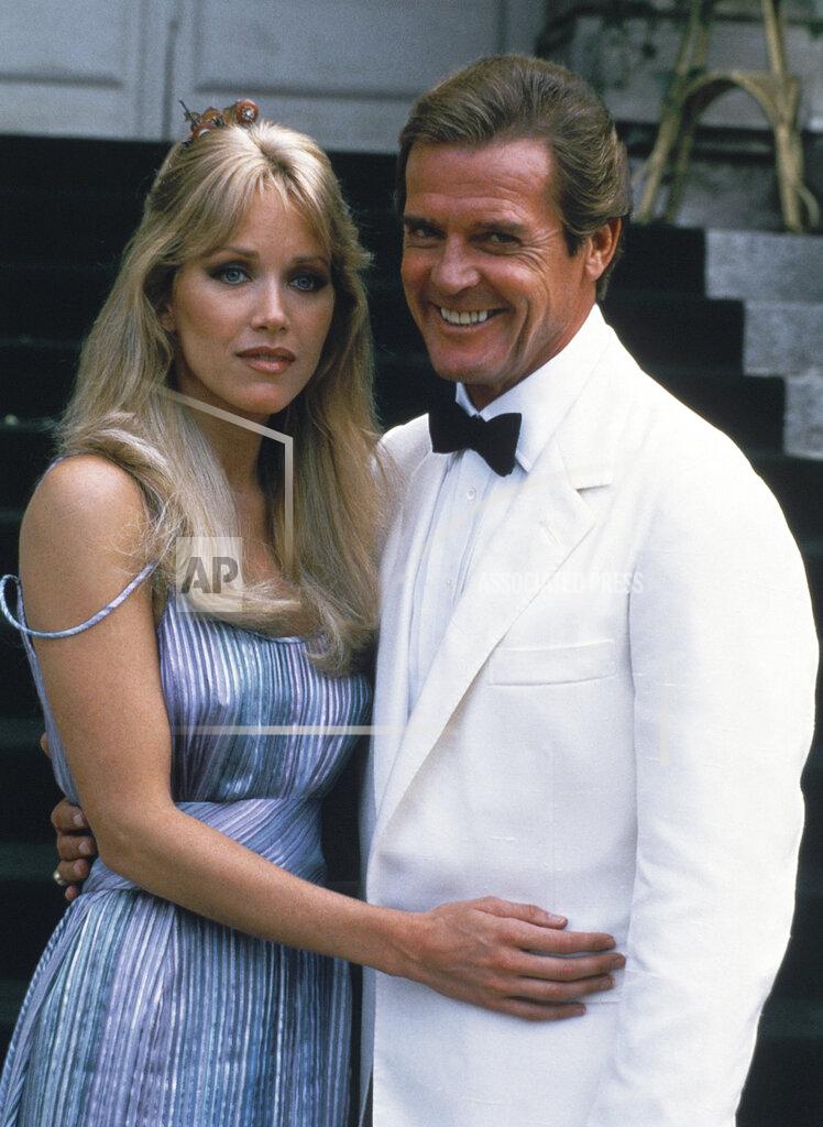 Alexis Duclos FILE - Actor Roger Moore, right, poses with his co-star Tanya Roberts from the James Bond film "A View to a Kill," outside of Château de Chantilly in Chantilly, France on Aug. 17, 1984. Roberts, who captivated James Bond in “A View to a Kill” and appeared in the sitcom “That ’70s Show,” died Monday, Jan. 4, 2021, several hours after she was mistakenly declared dead by her publicist and her partner. Roberts' partner Lance O'Brien confirmed her death Tuesday after picking up her personal effects at a Los Angeles hospital. She was 65. (AP Photo/Alexis Duclos, File)