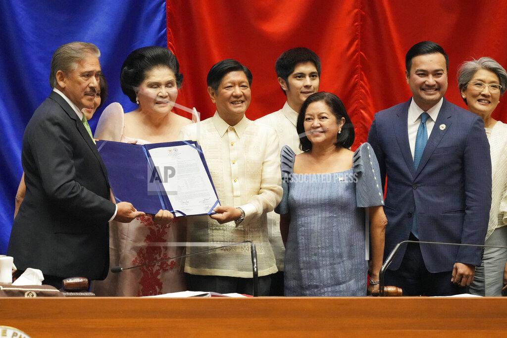 Aaron Favila President-elect Ferdinand 'Bongbong" Marcos Jr., 3rd from left, poses beside, from left, Senate President Vicente Sotto III, Imelda Marcos, Maria Louise Marcos, House Speaker Lord Allan Velasco and Irene Marcos during his proclamation ceremony at the House of Representatives, Quezon City, Philippines on Wednesday, May 25, 2022. Marcos Jr. was proclaimed the next president of the Philippines by a joint session of Congress Wednesday in an astonishingly huge electoral triumph 36 years after his father was ousted as a brutal dictator by a pro-democracy uprising. (AP Photo/Aaron Favila)