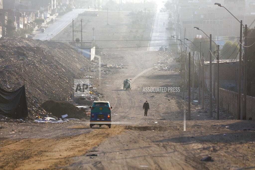 Guadalupe Pardo A voter walks towards a polling post during general elections amid the new coronavirus pandemic in Lima, Peru, Sunday, April 11, 2021. (AP Photo/Guadalupe Pardo)