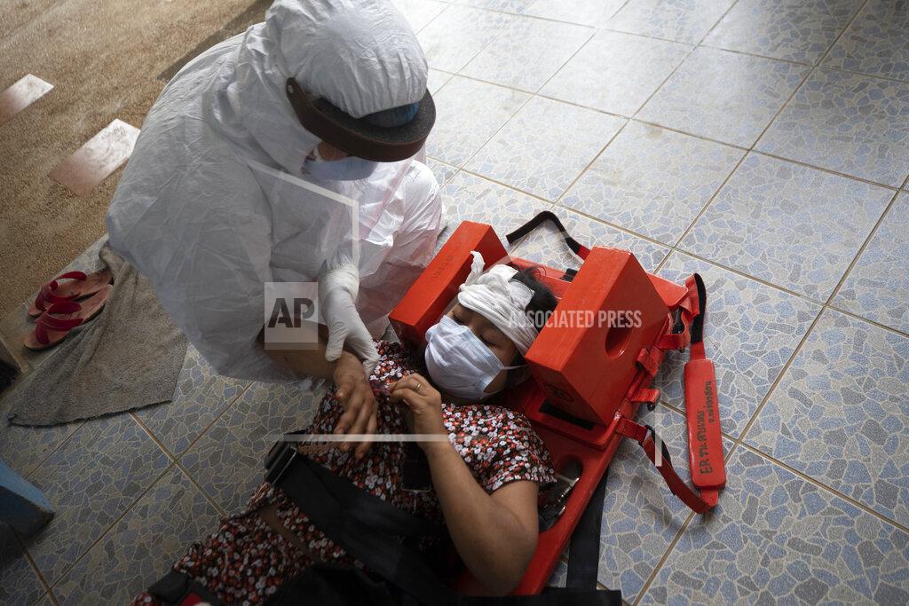 Sakchai Lalit FILE - In this March 30, 2021, file photo, a health worker attends to an injured Karen villager from Myanmar as she and others arrive at Ban Mae Sam Laep Health Center in Mae Hong Son province, Thailand. Far away in Myanmar’s borderlands, millions of others who hail from Myanmar’s minority ethnic groups are facing increasing uncertainty and waning security as longstanding conflicts between the military and minority guerrilla armies flare anew. (AP Photo/Sakchai Lalit, File)