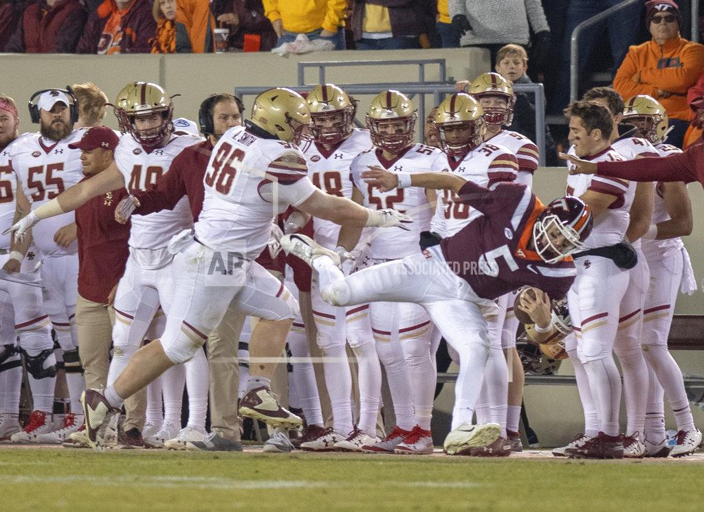 Matt Bell Virginia Tech quarterback Ryan Willis is shoved out of bounds by Boston College's Ray Smith during an NCAA college football game in Blacksburg, Va., Saturday, Nov. 3, 2018. (AP Photo/Matt Bell)