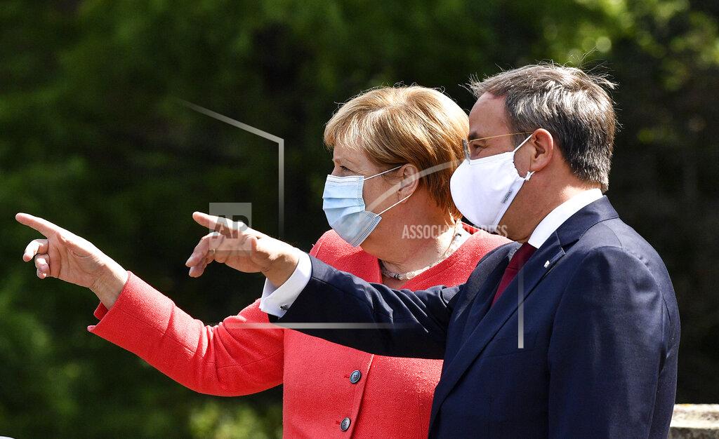 Martin Meissner FILE - In this Aug. 18, 2020 file photo, German chancellor Angela Merkel, left, wears a face mask due to the coronavirus pandemic as she meets Governor Armin Laschet, right, during her visit at Germany's most populated federal state North Rhine-Westphalia in Duesseldorf, Germany. The coronavirus pandemic is colliding with politics as Germany embarks on its vaccination drive and one of the most unpredictable election years in its post-World War II history. (AP Photo/Martin Meissner, File)