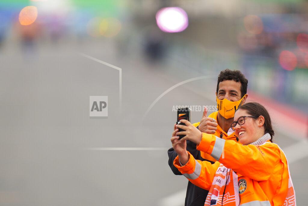 Francisco Seco Mclaren driver Daniel Ricciardo of Australia has a picture with a fan ahead of Sunday's Formula One Dutch Grand Prix at the Zandvoort racetrack, Netherlands, Thursday, Sept. 2, 2021. (AP Photo/Francisco Seco)