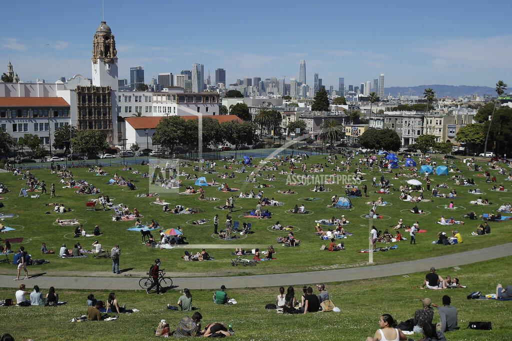 Jeff Chiu FILE - In this May 24, 2020, file photo, visitors set up inside circles designed to help prevent the spread of the coronavirus by encouraging social distancing at Dolores Park in San Francisco. Los Angeles and San Francisco are poised Tuesday, May 4, 2021, to be the only major urban areas in the state to meet guidelines to move into the least-restrictive tier, amid the pandemic. It's a remarkable turnaround considering California was the epicenter of the virus outbreak in the U.S. just a few months earlier. (AP Photo/Jeff Chiu, File)