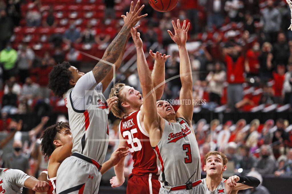 Brad Tollefson Texas Tech's Kyler Edwards (11), Clarence Nadolny (3) and Oklahoma's Brady Manek (35) try to rebound the ball during the second half of an NCAA college basketball game, Monday, Feb. 1, 2021, in Lubbock, Texas. (AP Photo/Brad Tollefson)