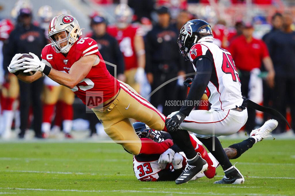 John Hefti San Francisco 49ers tight end George Kittle, left, runs against Atlanta Falcons defensive back Blidi Wreh-Wilson (33) and linebacker Deion Jones (45) during the first half of an NFL football game in Santa Clara, Calif., Sunday, Dec. 15, 2019. (AP Photo/John Hefti)