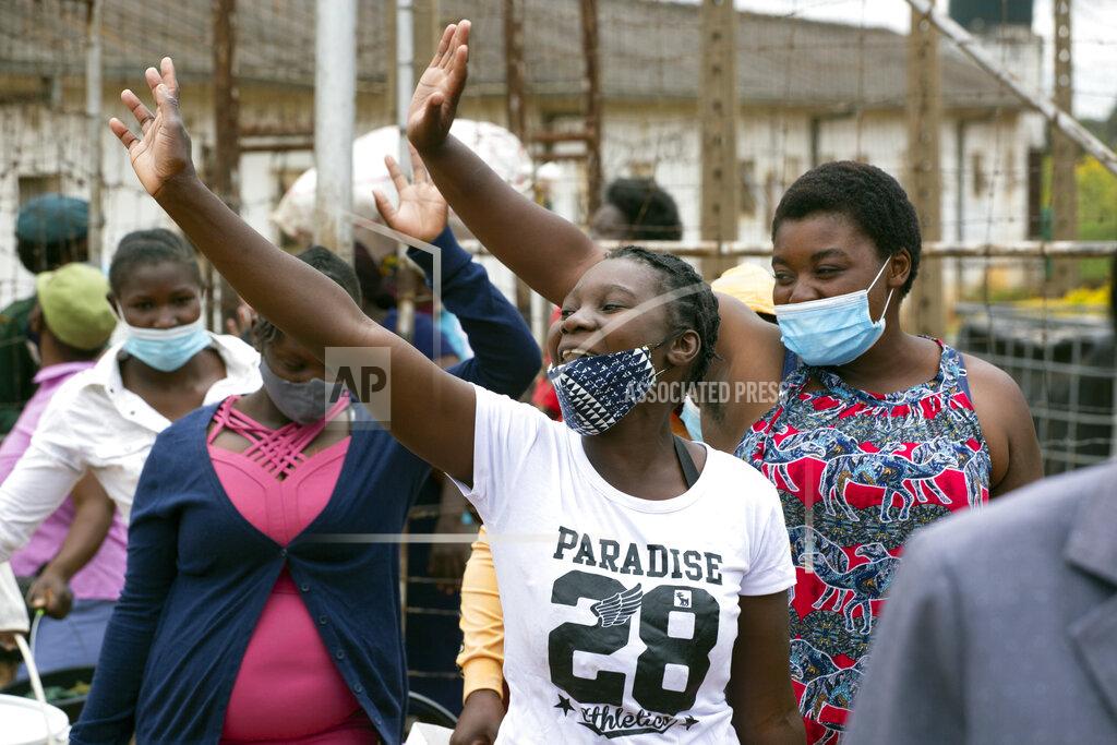 Tsvangirayi Mukwazhi Female prsioners wave goodbye to their fellow inmates following their release from Chikurubi prison on the outskirts of Harare, Saturday, April 17, 2021. Zimbabwe began the release of about 3,000 prisoners under a presidential amnesty aimed at easing congestion and minimizing the threat of COVID-19 across the country's overcrowded jails. (AP Photo/Tsvangirayi Mukwazhi)