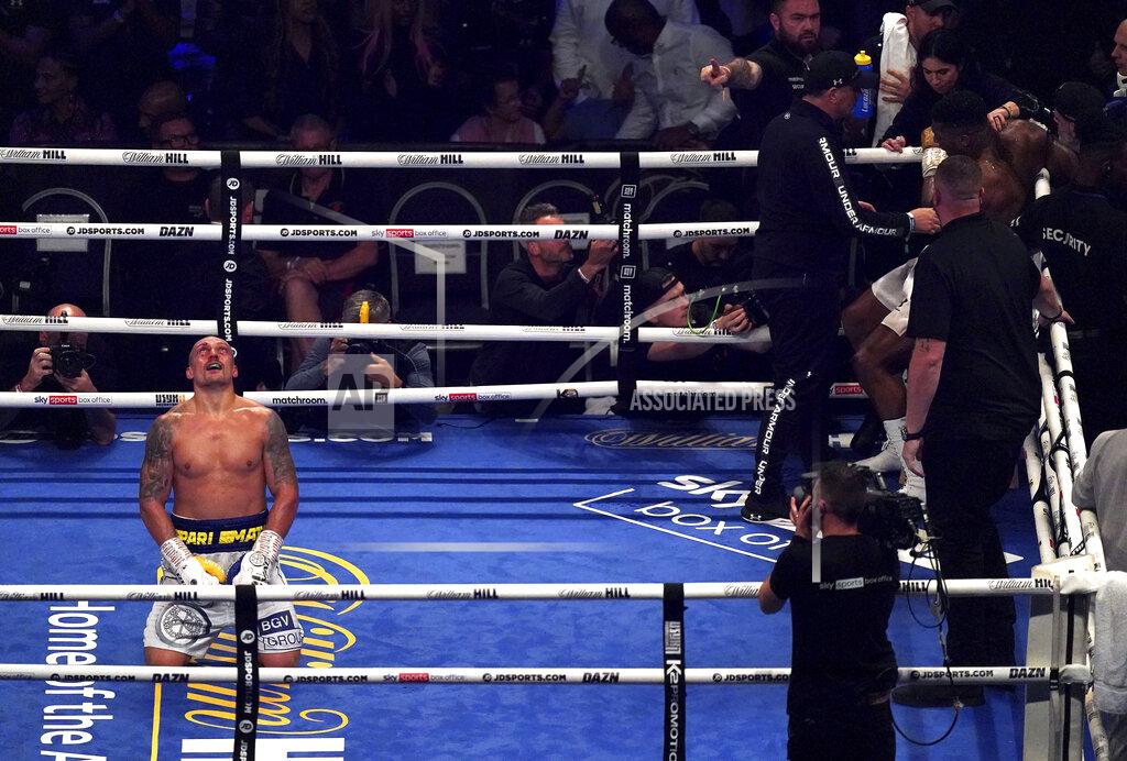 Nick Potts Oleksandr Usyk, left, of Ukraine celebrates after winning the WBA (Super), WBO and IBF boxing title bout against Anthony Joshua, right, of Britain at the Tottenham Hotspur Stadium in London Saturday Sept. 25, 2021. (Nick Potts/PA via AP)