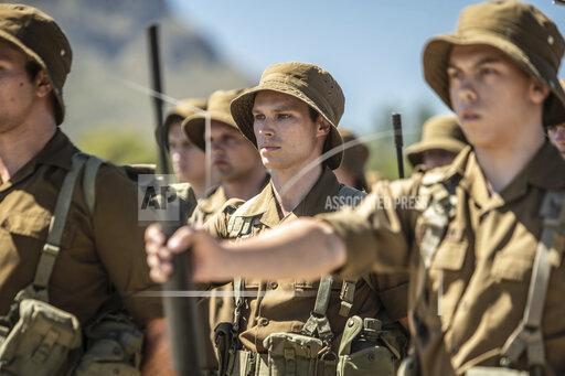 Daniel Rutland Manners This image released by IFC Films shows Kai Luke Brummer, center, in a scene from "Moffie." (IFC Films via AP)