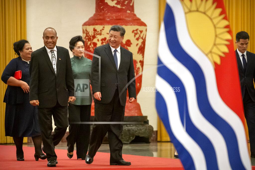 Mark Schiefelbein FILE - Kiribati's President Taneti Maamau, left, and Chinese President Xi Jinping walk together during a welcome ceremony at the Great Hall of the People in Beijing, Monday, Jan. 6, 2020. China wants 10 small Pacific nations to endorse a sweeping agreement covering everything from security to fisheries in what one leader warns is a “game-changing” bid by Beijing to wrest control of the region. (AP Photo/Mark Schiefelbein, File)