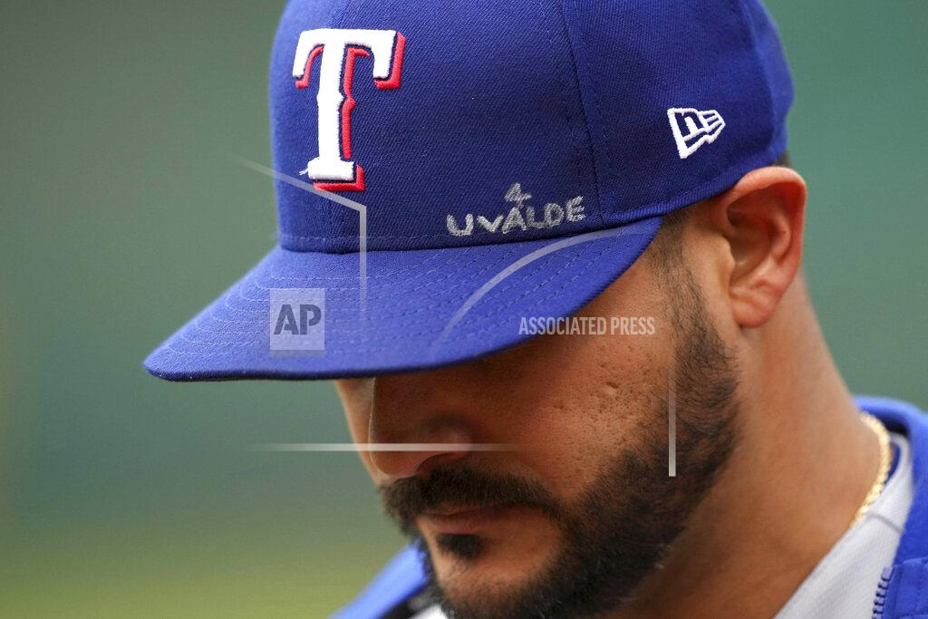 Darren Yamashita Texas Rangers' Martin Perez walks to the dugout with an inscription on his hat dedicated to the victims of the Uvalde, Texas, school shooting, before the team's baseball game against the Oakland Athletics on Thursday, May 26, 2022, in Oakland, Calif. (AP Photo/Darren Yamashita)